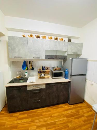 a kitchen with a sink and a refrigerator at Adventure Riders Mongolia in Ulaanbaatar
