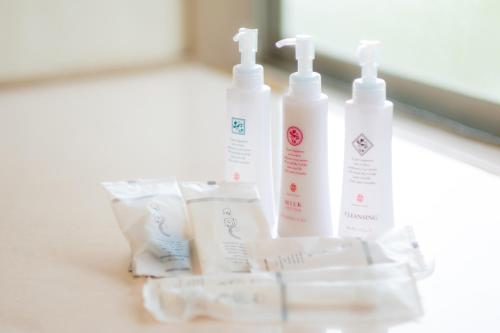 a group of four bottles of sunscreen sitting on a counter at Hotel Lucia at Maebashi Akagi in Maebashi