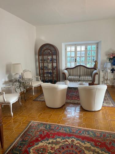 a living room with white furniture and a couch at Da Tea in San Teodoro
