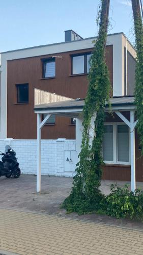 a building with a motorcycle parked in front of it at Apartamenty Skórzewo in Skórzewo