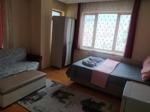 a bedroom with a bed and a window and a chair at Opium otel in Afyon