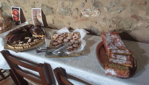 a table with bread and a plate of food on it at Casa Vacanze Nicola e Lina in Tortorella