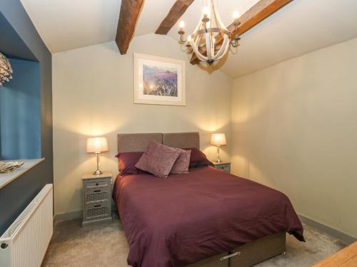 a bedroom with a bed and two night stands at The Lookout in Holmfirth