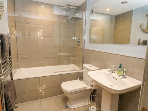 a bathroom with a toilet and a sink and a shower at The Lookout in Holmfirth