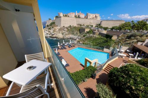 vistas a la piscina desde el balcón de un hotel en Hotel Saint Christophe, en Calvi