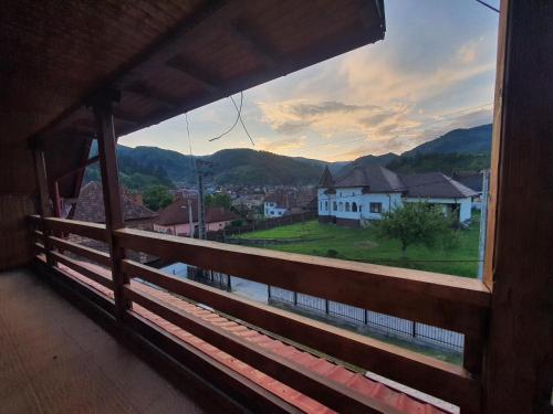 a window with a view of a town and mountains at Pensiunea Geta in Rucăr
