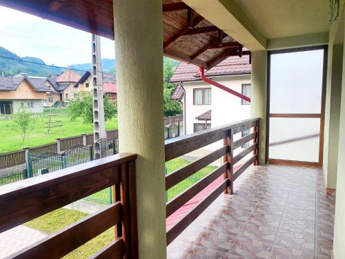 a balcony with a view of a house at Pensiunea Geta in Rucăr