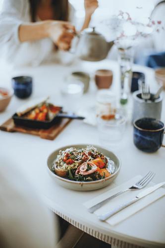a table with a plate of food on it at Amante Boutique in Kuressaare