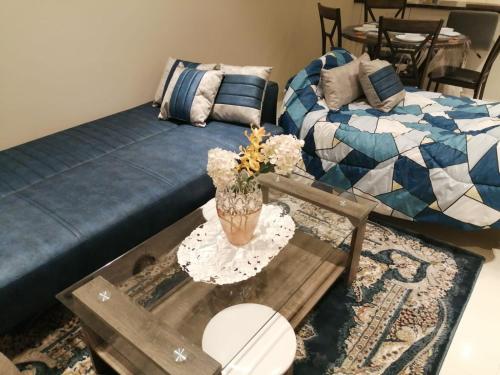 a living room with a couch and a coffee table at Blue Hawana in Salalah