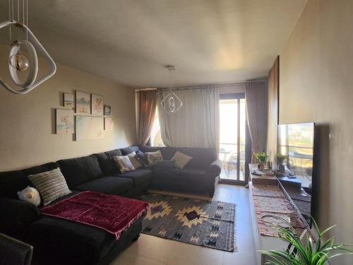 a living room with a couch and a window at Azha Ain Sokhna apartment in Ain Sokhna