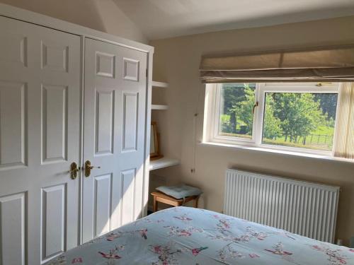 a bedroom with a bed and a window at Welsh wonderland in Builth Wells