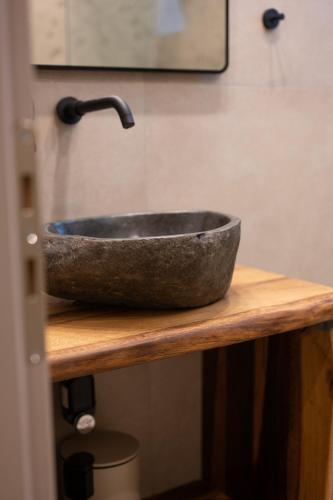 a stone sink on a counter in a bathroom at MiLiON RESIDENCES in Parga