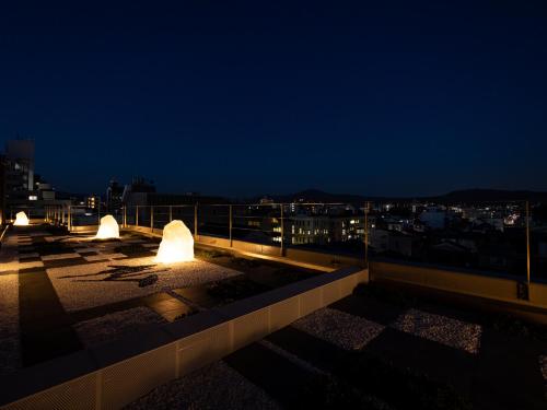 a view of a city skyline at night at La'gent Hotel Kyoto Nijo in Kyoto