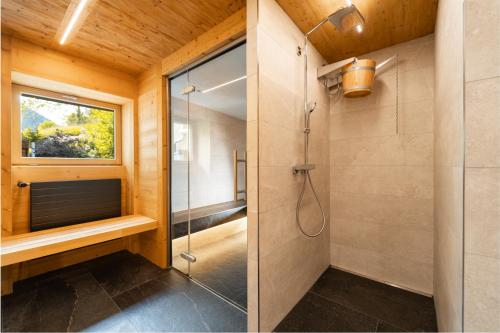 a bathroom with a shower and a glass shower stall at Hôtel du Glacier in Champex