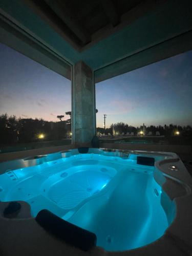 a jacuzzi tub with a view of the night at Villa Rocca - Rooms&SPA in Pizzo
