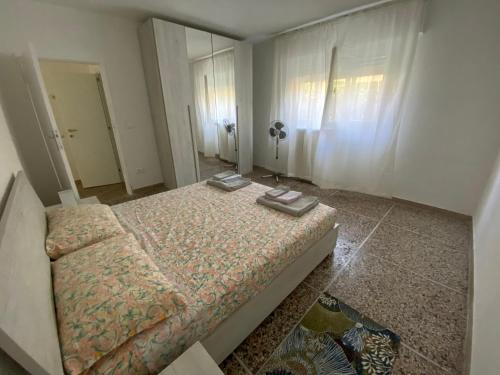 a bedroom with a bed and a mirror at le tre isolette a 200m dal mare in Marina di Pisa
