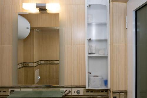 a kitchen with a large mirror and a sink at Studio Treti Mart South in Primorsko