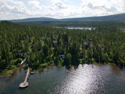 an aerial view of a lake with trees at Aurora Camp Kurravaara in Kurravaara