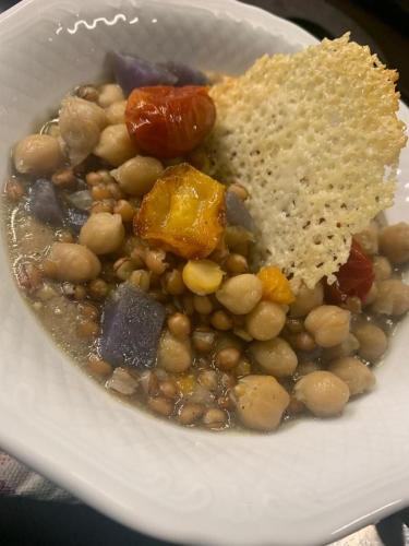 a white plate of food with beans and bread at Palazzetto Ardi in Torri di Confine