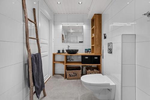 a bathroom with a toilet and a sink at SKI INN/OUT - 4-room apartment w/3 bedroom in Gaustablikk