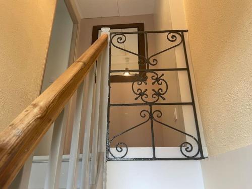 a staircase with a wrought iron railing next to a door at GITE DE FAMILLE in Dieppe