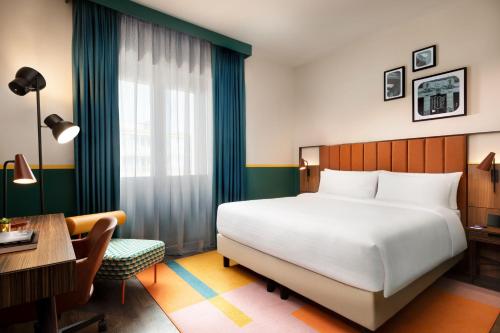 a hotel room with a bed and a desk and a desk at Duo Milan Porta Nuova, a Tribute Portfolio Hotel in Milan