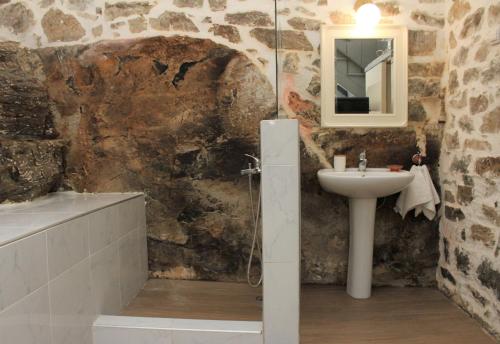 a bathroom with a sink and a bath tub at Theane lime 1 in Kavala
