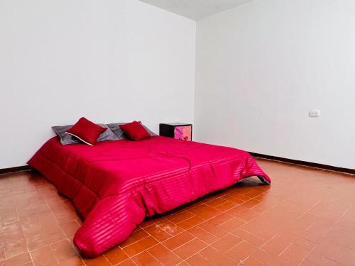 a large red bed in a white room at Museo del Oro in Bogotá