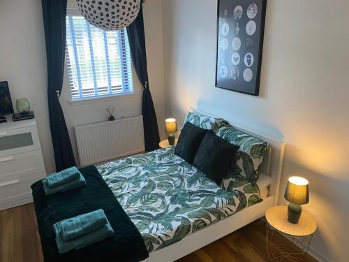 a small bedroom with a bed and a window at Perfectly situated luxury 2 bedroom apartment in Glasgow