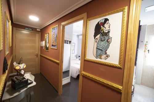 a bathroom with a picture of a woman on the wall at DEL ARZOBISPO in Plasencia