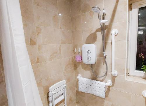 a shower with a shower head in a bathroom at Farm View Cottage Castlerea by Trident Holiday Homes in Castlerea