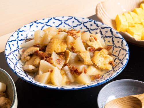 a blue and white bowl of food on a table at La'gent Hotel Kyoto Nijo in Kyoto