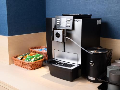 a coffee machine sitting on top of a counter at La'gent Hotel Kyoto Nijo in Kyoto