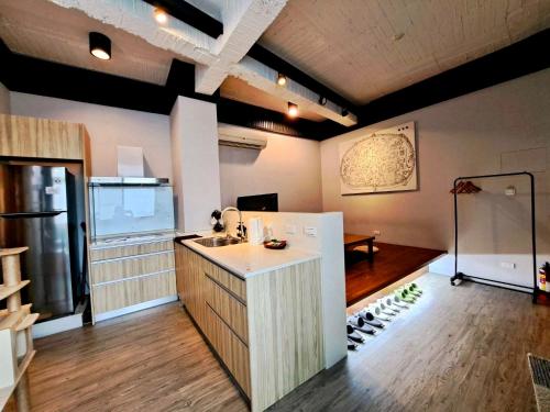 a kitchen with a sink and a counter with wine bottles at 小城門 親子寵物包棟民宿 City Door Family and Pet-Friendly Entire Homes in Tainan