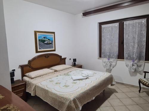 a bedroom with a bed and a window at Casa Carpineta in Manciano
