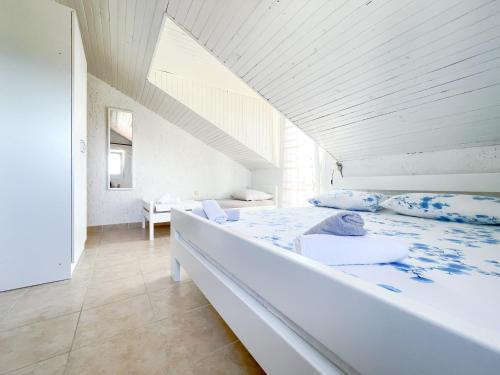 a bedroom with a large white bed with blue pillows at Bed&Breakfast Drage in Drage