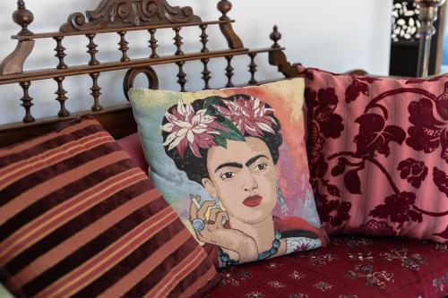 a pillow with a painting of a woman on it at Kastelokampos Art House in Patra
