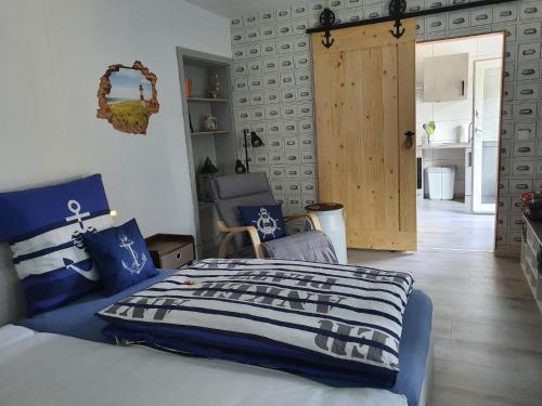 a bedroom with a bed with a blue and white comforter at Lighthouse in Drage