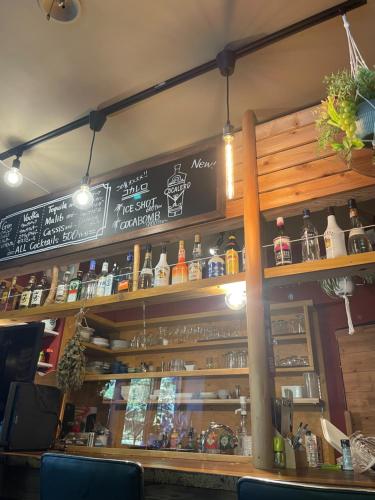 a bar in a restaurant with a sign on the wall at 伊豆 白浜 ゲストハウス茉心 in Shimoda