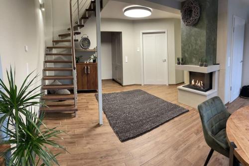 a living room with a staircase and a fireplace at Excl. Maisonette Ferienwohnung in Coesfeld