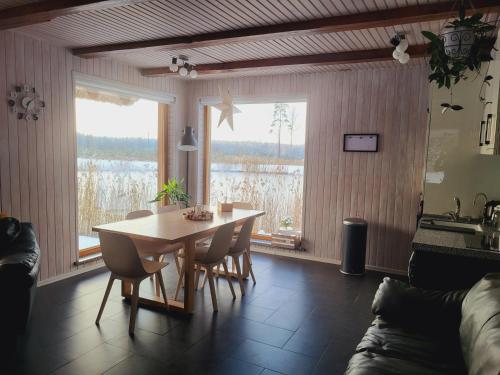 a dining room with a table and chairs and a window at Rīti Siguldā in Stīveri