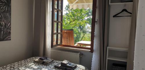 a bedroom with a bed and a window with a balcony at Apartment Doris in Opatija