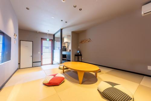 a living room with a wooden table and a table sidx sidx sidx at Irodori Hotel SORA in Fukuoka