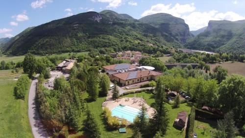 an aerial view of a house in the mountains at Hotel Le Grotte in Genga