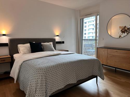 een slaapkamer met een bed en een grote spiegel bij 2-Zimmer Wohnung in Oberlaa mit privatem Tiefgaragen Platz in Wenen