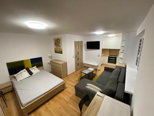 a living room with a bed and a couch at Kawalerka Zatorze nie wystawiam FV in Wałcz