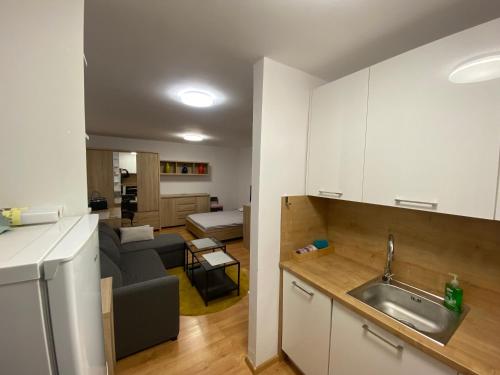 a kitchen and a living room with a couch at Kawalerka Zatorze nie wystawiam FV in Wałcz