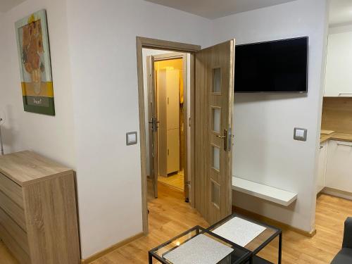 a living room with a flat screen tv on a wall at Kawalerka Zatorze nie wystawiam FV in Wałcz