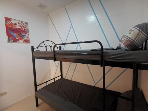 a black bunk bed in a room with a window at Transient San Pablo Lagun in San Pablo