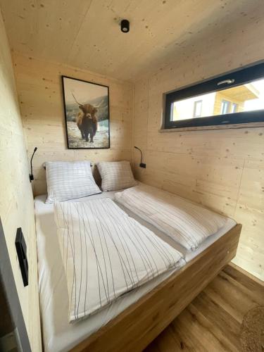 a small room with two beds in a cabin at Ferienresort Edersee GmbH in Hemfurth-Edersee